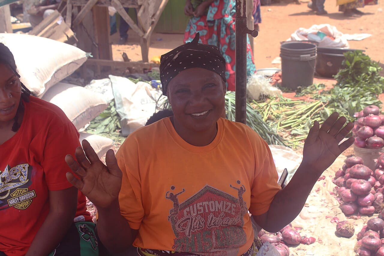 A smiling market woman at her stall in Kakuri market, Kaduna